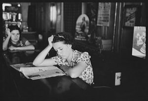 Chica leyendo la prensa en un bar de Tower, Minnesota (1937).